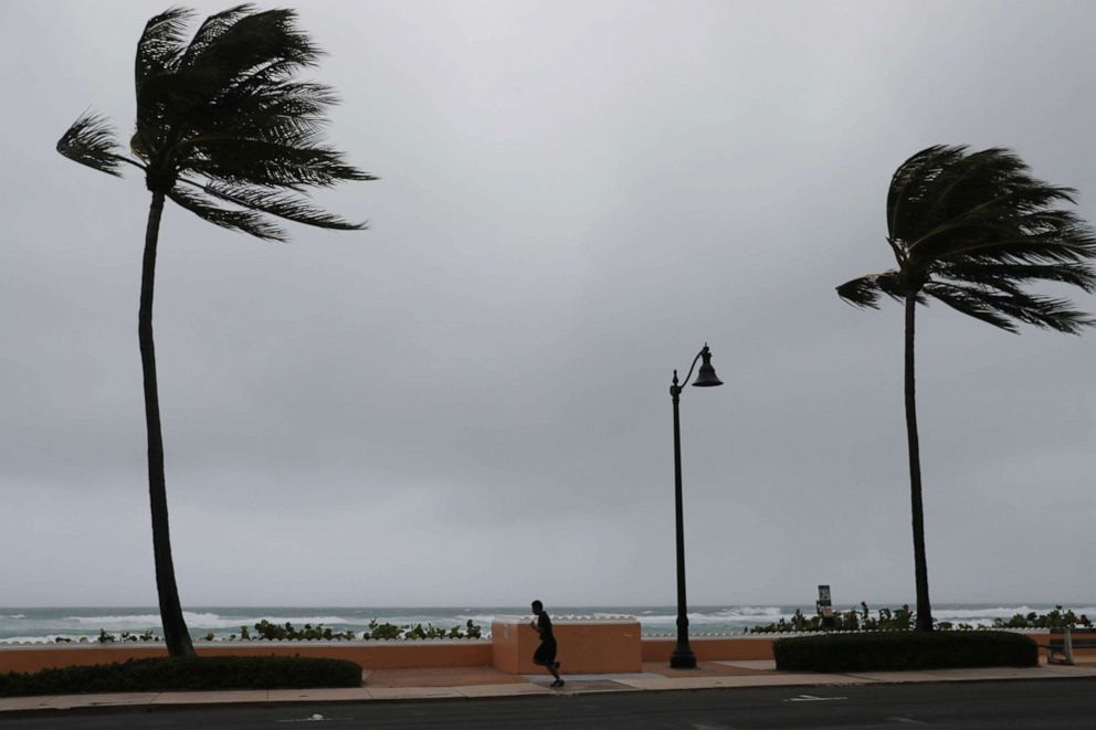 PHOTO: A runner is seen as Tropical Storm Isaias passes through the area, Aug. 2, 2020, in Deerfield Beach, Florida.