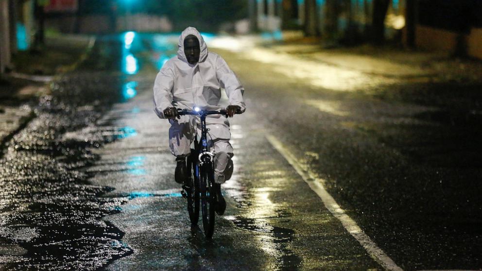 PHOTO: A man wearing a protective suit cycles on a street, as Hurricane Melissa approaches, in Kingston, Jamaica, October 27, 2025.