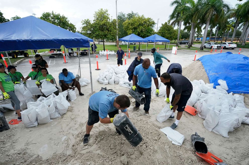 PHOTO: City workers fill sandbags at a drive-thru sandbag distribution event for residents ahead of the arrival of rains associated with tropical depression Fred, Aug. 13, 2021, at Grapeland Park in Miami.