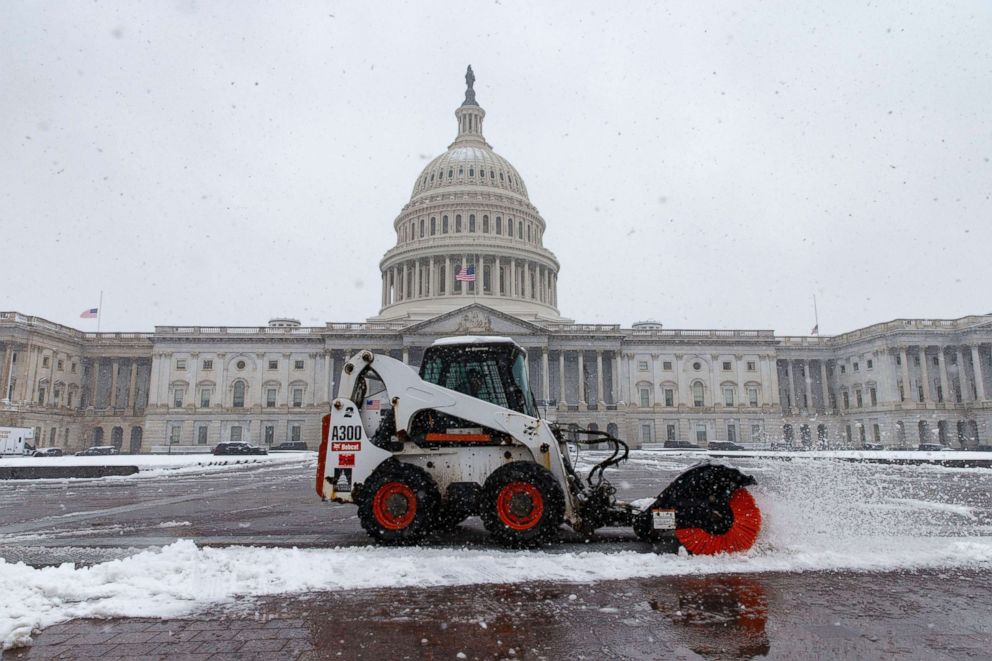 PHOTO: An architect of the U.S. Capitol staff member uses a Bobcat to clear snow from the U.S. Capitol plaza on a snowy afternoon in Washington, March 21, 2018.