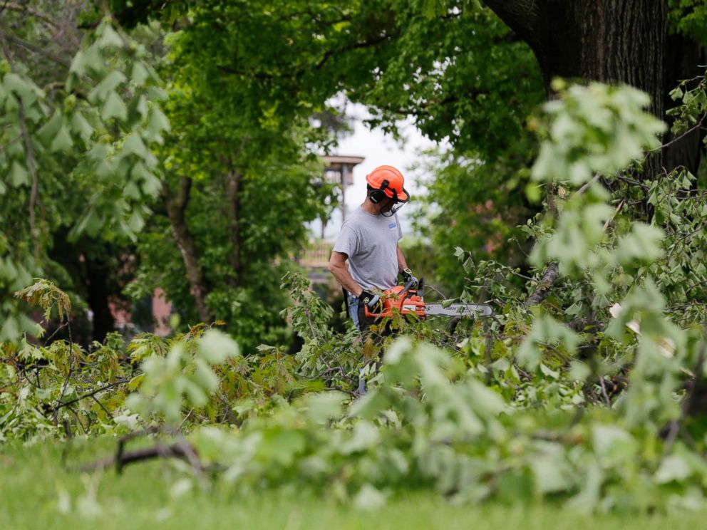 PHOTO: A man clears downed branches and debris on the grounds of Washington's Headquarters State Historic Site in Newburgh, N.Y., May 16, 2018.