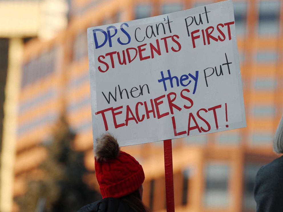 PHOTO: A teacher holds a placard during a rally by teachers from the Denver Public Schools outside the State Capitol, Jan. 30, 2019, in Denver.