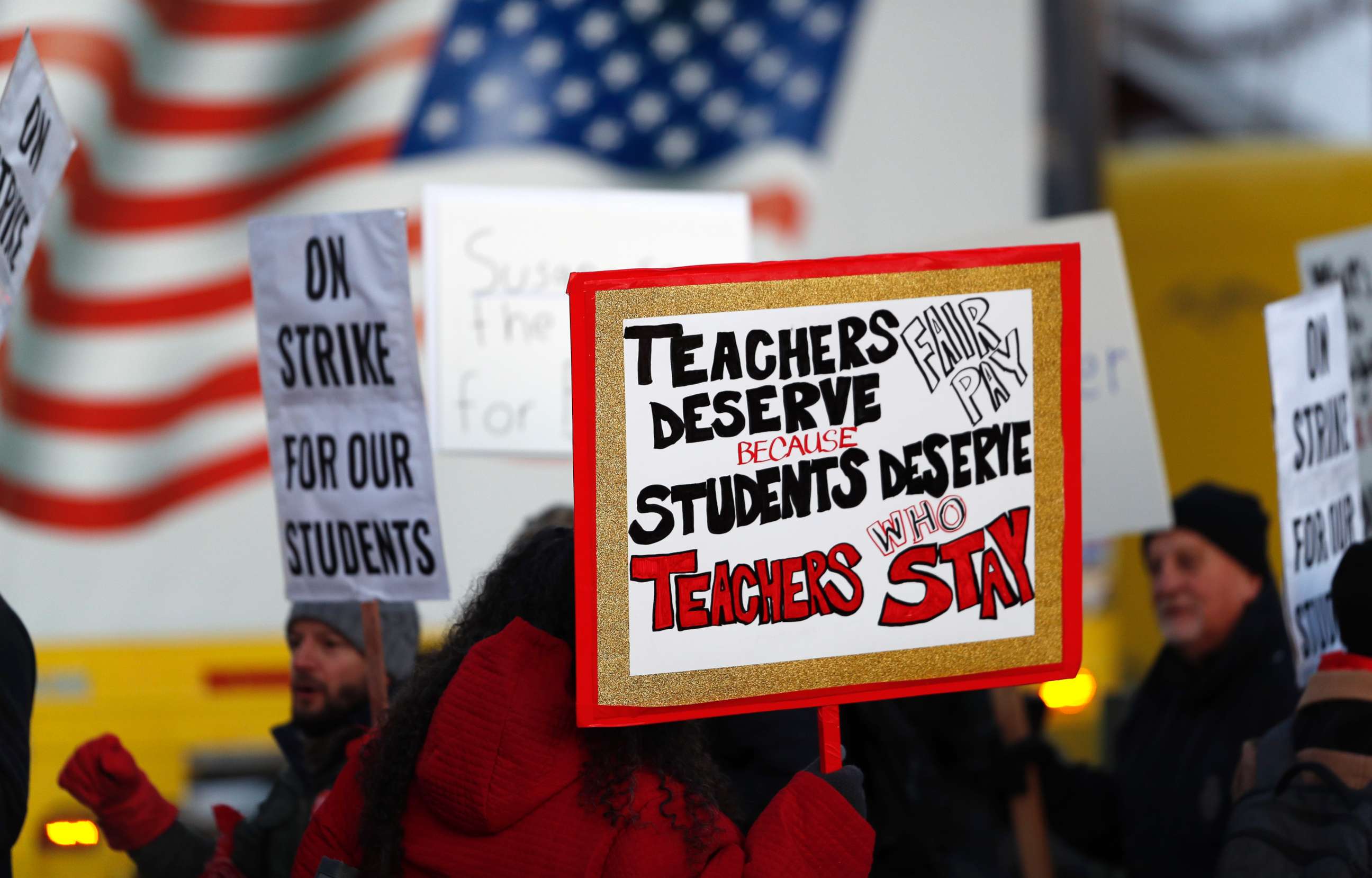 PHOTO: Teachers carry placards as they walk a picket line outside South High School,, Feb. 11, 2019, in Denver.