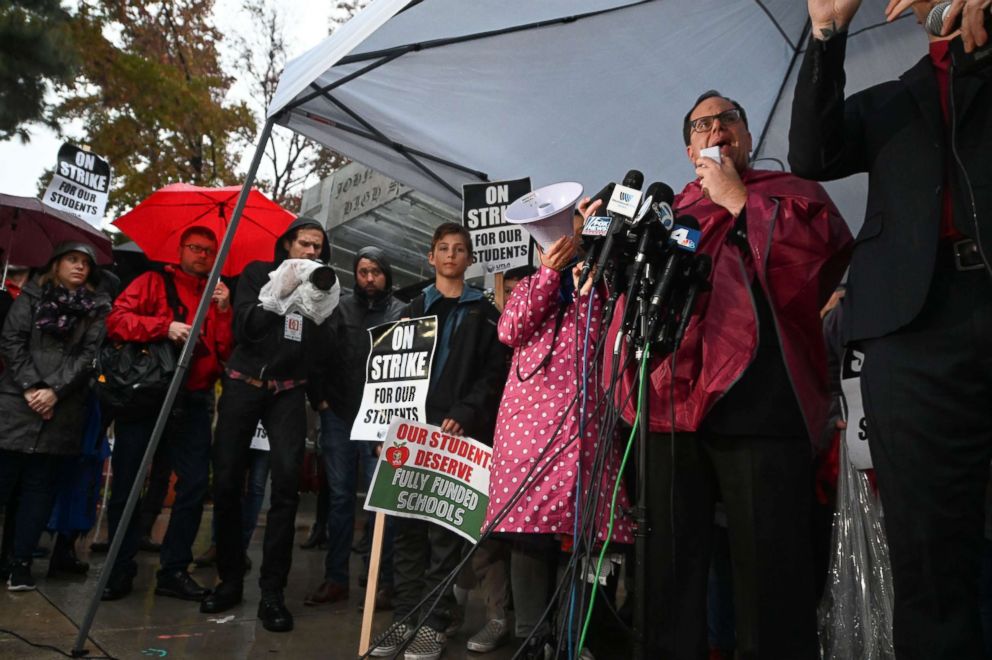 PHOTO: United Teachers Los Angeles (UTLA) union President Alex Caputo-Pearl (R) speaks to striking teachers and their supporters outside John Marshall High School in Los Angeles on the first day of the teachers' strike, Jan. 14, 2019.