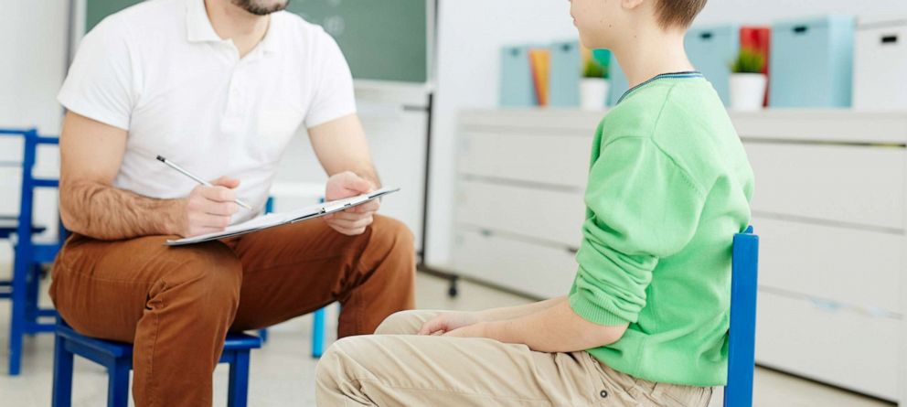 PHOTO: A student sitting with a counselor at school.