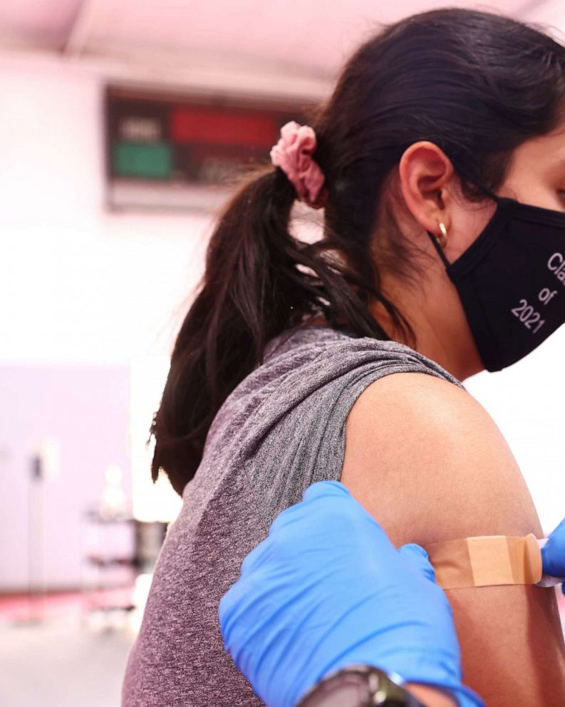 PHOTO: A student wearing a "Class of 2021" face mask is bandaged after receiving a dose of a COVID-19 vaccine at a pop-up vaccination clinic at James Jordan Middle School in Winnetka, California, on July 6, 2021.