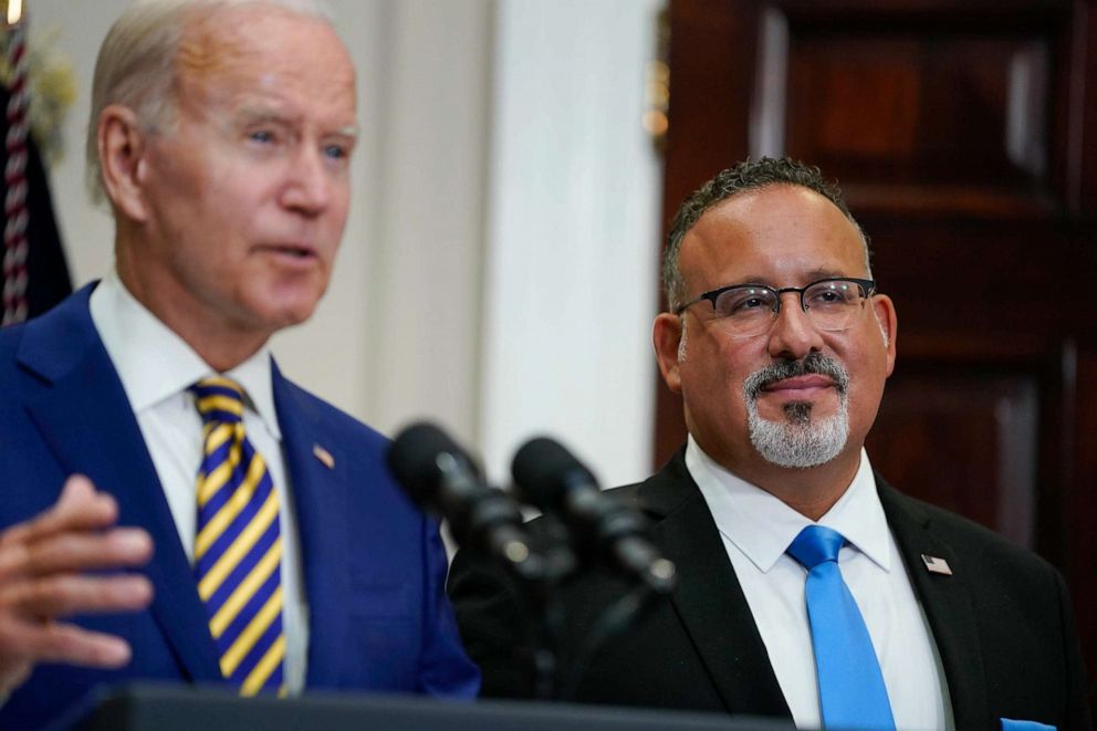 PHOTO: Education Secretary Miguel Cardona listens as President Joe Biden speaks about student loan debt forgiveness in the Roosevelt Room of the White House, Aug. 24, 2022.