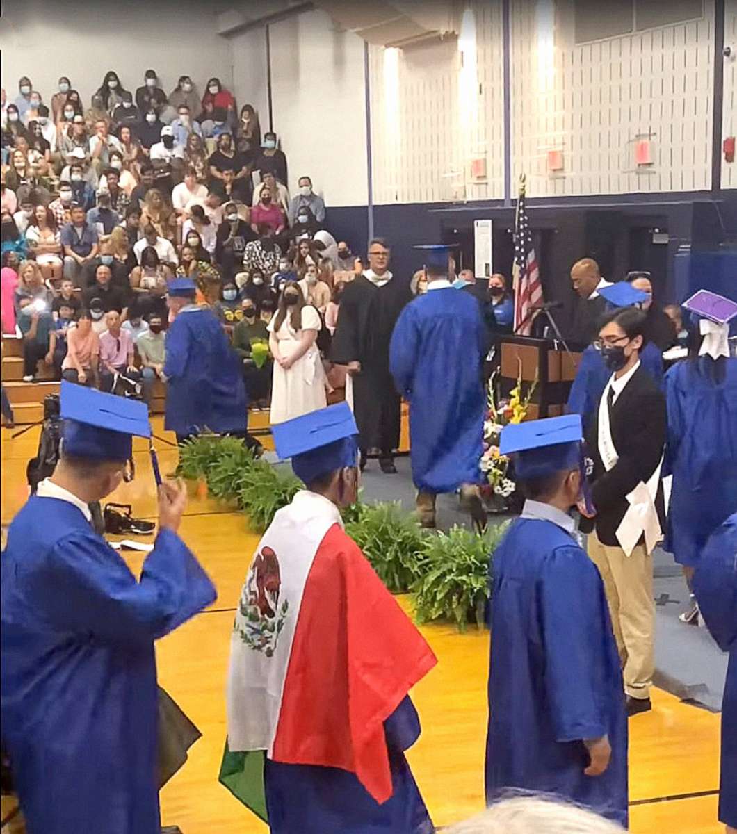 PHOTO: A student wears a Mexican flag over his graduation gown at his graduation ceremony, in an image taken from video provided by graduation attendee Adolfo Hurtado.