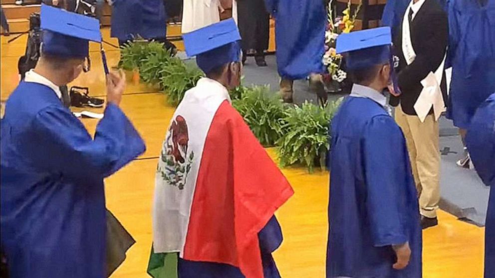 PHOTO: A student wears a Mexican flag over his graduation gown at his graduation ceremony, in an image taken from video provided by graduation attendee Adolfo Hurtado.