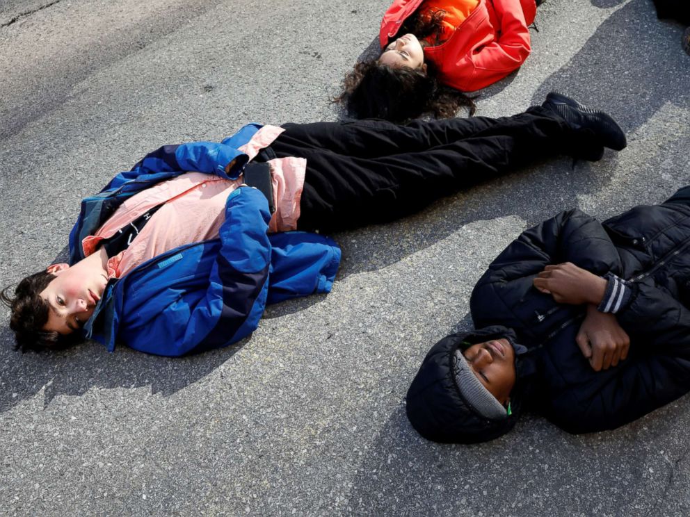 PHOTO: Students from Fiorello H. Laguardia High School lie down on West 62nd street in support of the National School Walkout in the Manhattan borough of New York, March 14, 2018.