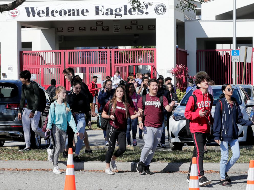PHOTO: Students walk out of Marjory Stoneman Douglas High School, as part of a nationwide protest against gun violence, March 14, 2018, in Parkland, Fla.
