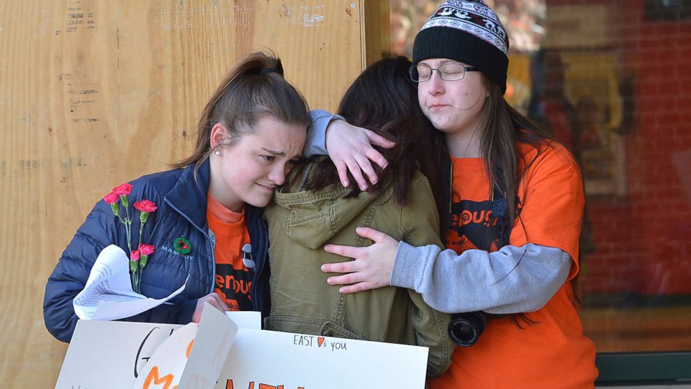 PHOTO: East chapel Hill students hug as they take part in a student walkout on March 14, 2018 in Chapel Hill, N.C.