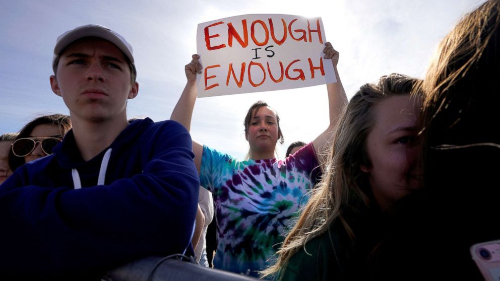Columbine High School student Leah Zunder holds a sign during a National School Walkout in Littleton, Colo., on March 14, 2018 to honor the 17 students and staff members killed at Marjory Stoneman Douglas High School in Parkland, Fla.