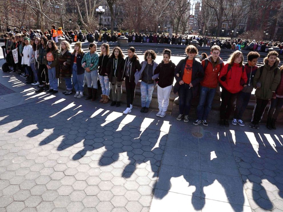 PHOTO: Students from Harvest Collegiate High School form a circle around the fountain in Washington Square Park, March 14, 2018, in N.Y. to take part in a national walkout to protest gun violence.