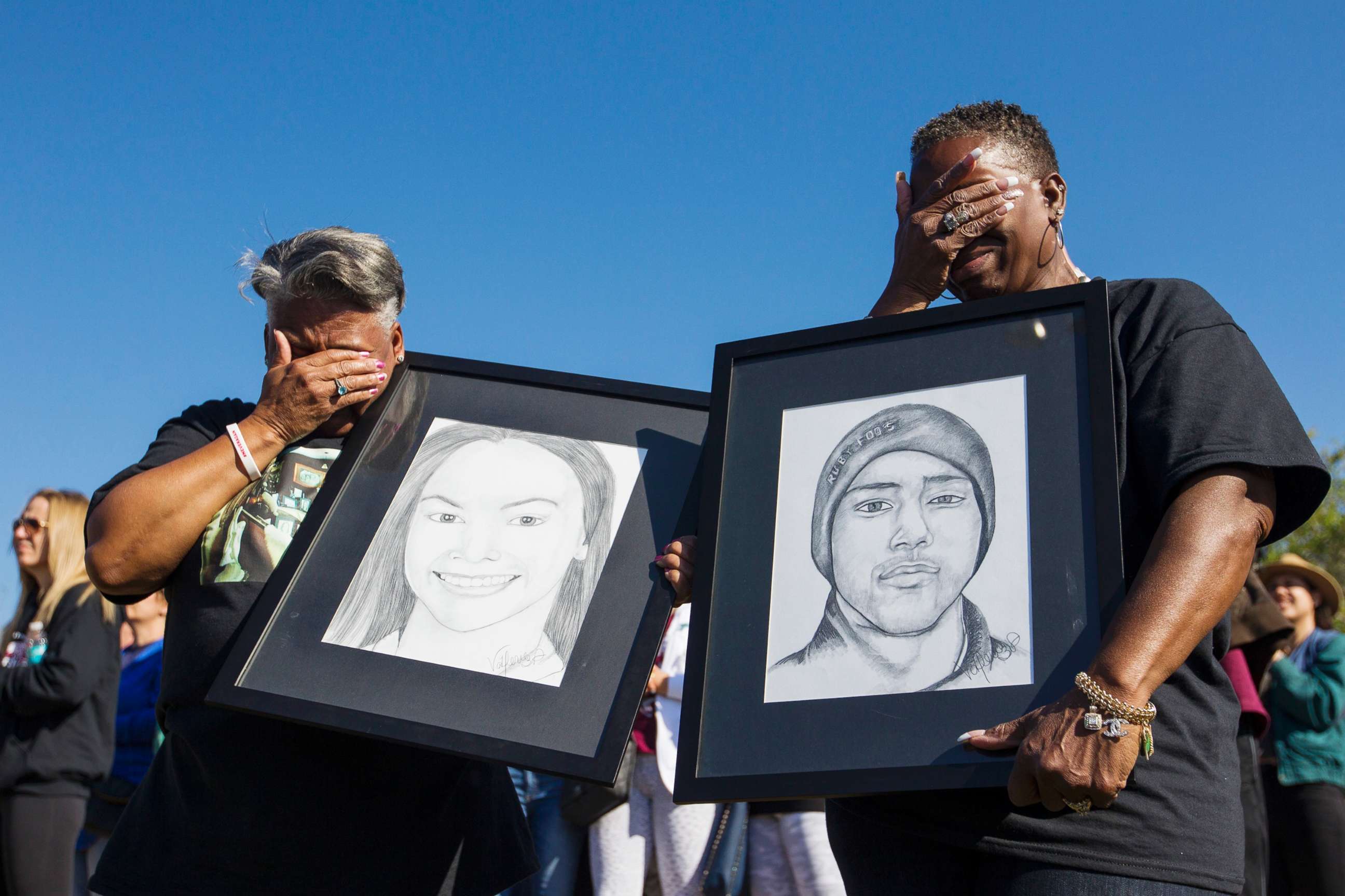 PHOTO: Pat Gibson, left, and Valerie Davis cry while holding pictures of two of the victims killed in the Parkland shooting during the one-month anniversary walkouts to protest gun violence, outside Marjory Stoneman Douglas High School, March, 14, 2018.