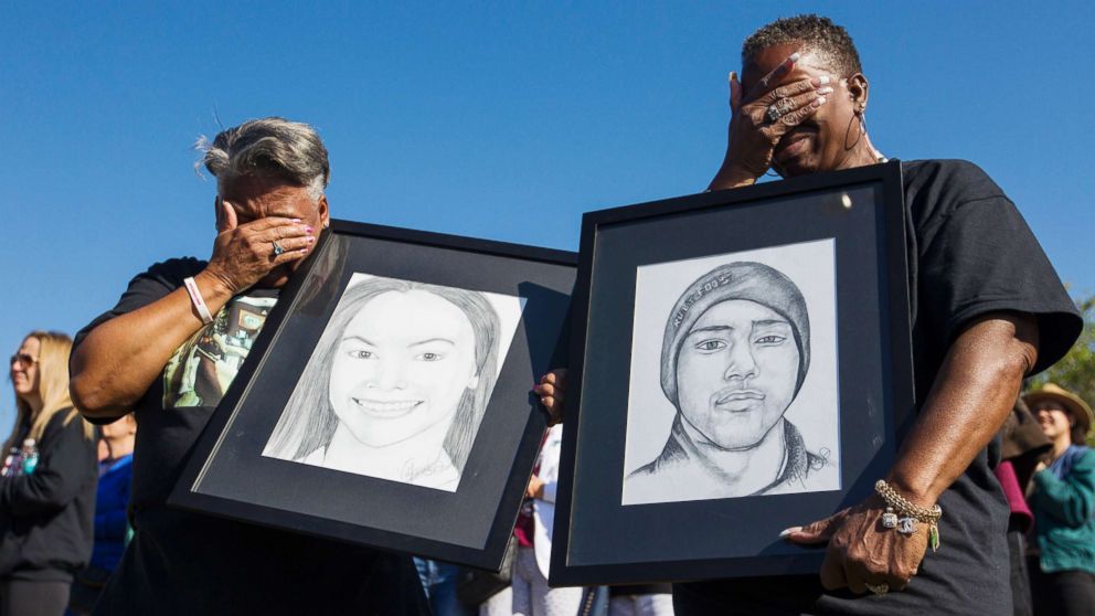 PHOTO: Pat Gibson, left, and Valerie Davis cry while holding pictures of two of the victims killed in the Parkland shooting during the one-month anniversary walkouts to protest gun violence, outside Marjory Stoneman Douglas High School, March, 14, 2018.