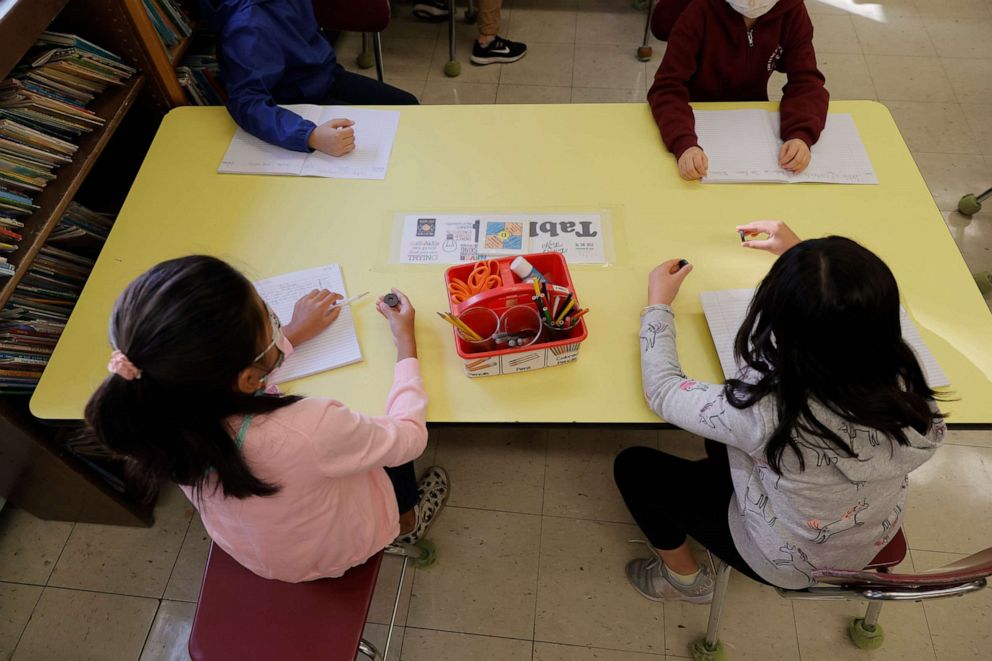 PHOTO: Masked students participate in a lesson in their classroom at Yung Wing School P.S. 124 on Sept. 27, 2021, in New York.
