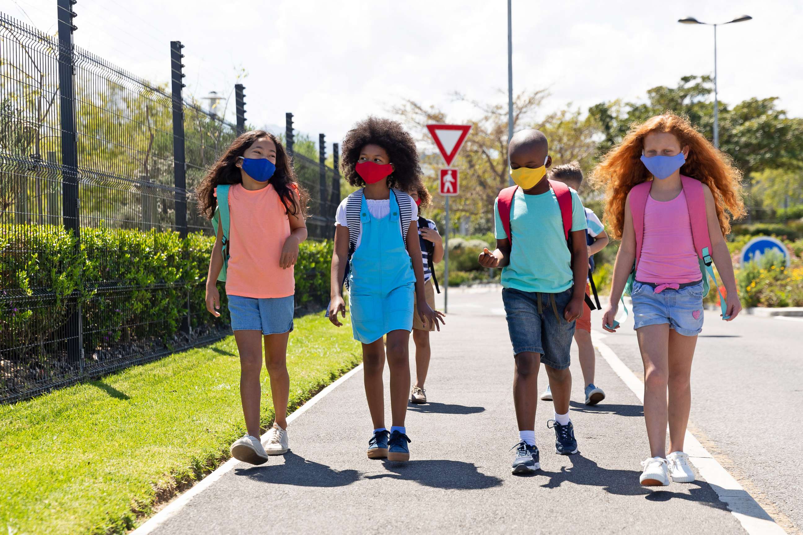 PHOTO: School children wearing face masks are pictured walking on the street in this undated stock image.