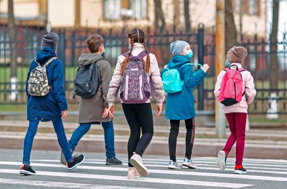 PHOTO: School children wearing face masks are pictured crossig the street in this undated stock image.