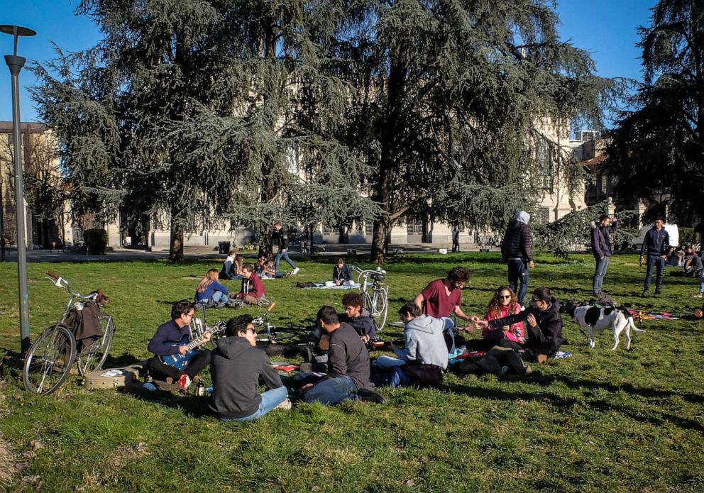 PHOTO: Students of the Milan's Politecnico University gather in a park outside their  university, Milan, Italy, March 4, 2020. The government has decided to close schools and universities until mid-March to reduce the risk of contagion of the coronavirus.