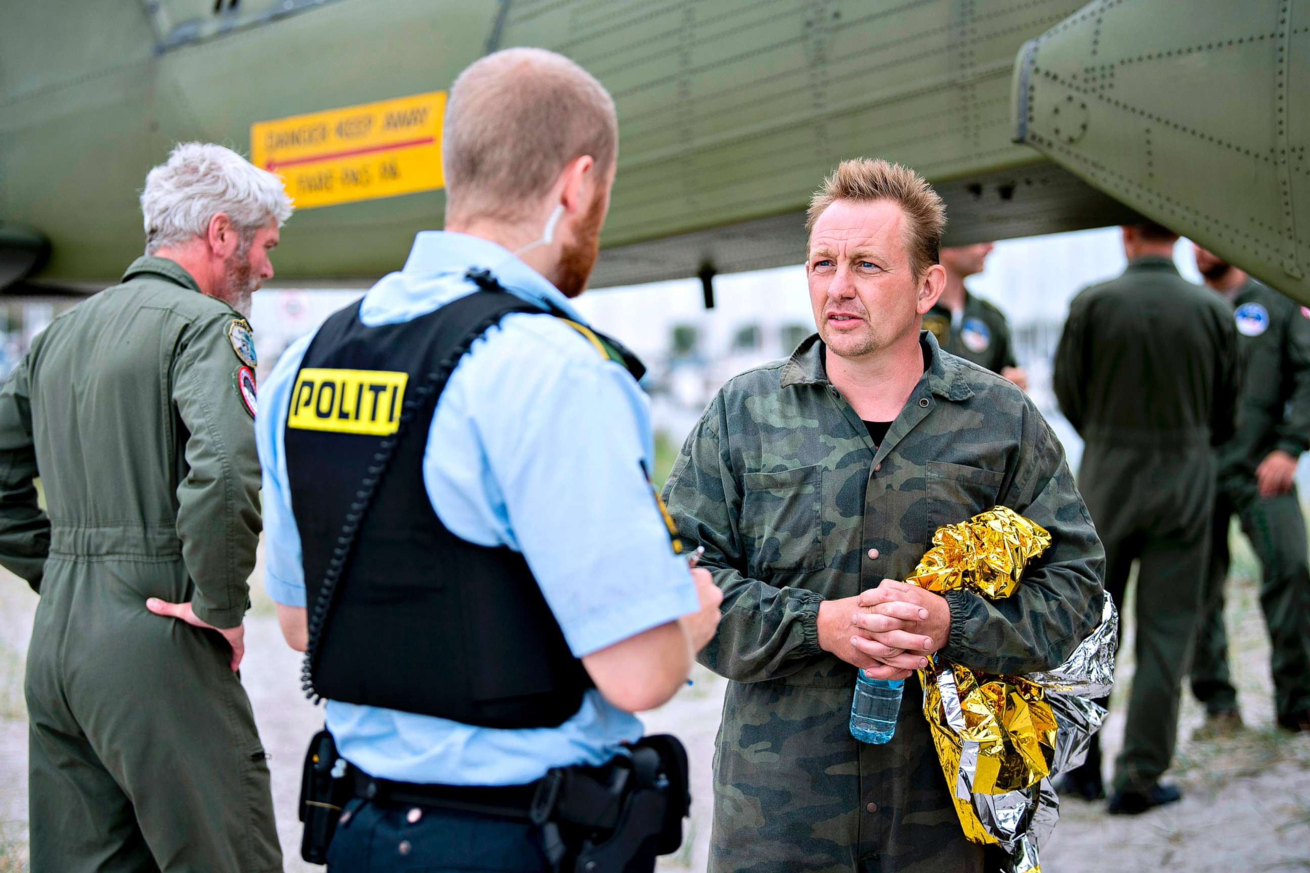 PHOTO: Peter Madsen (R), builder and captain of the private submarine "UC3 Nautilus" talks to a police officer in Dragoer Harbor south of Copenhagen, Aug. 11, 2017.