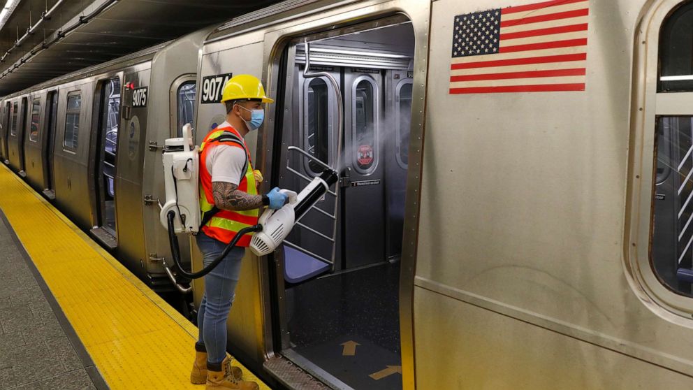 PHOTO: MTA Subway car cleaners pictured doing their jobs at the 96th street station in Uptown, Manhattan on May 26, 2020, in New York City.