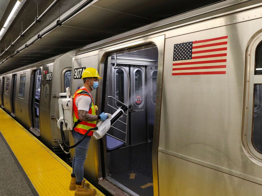 PHOTO: MTA Subway car cleaners pictured doing their jobs at the 96th street station in Uptown, Manhattan on May 26, 2020, in New York City.