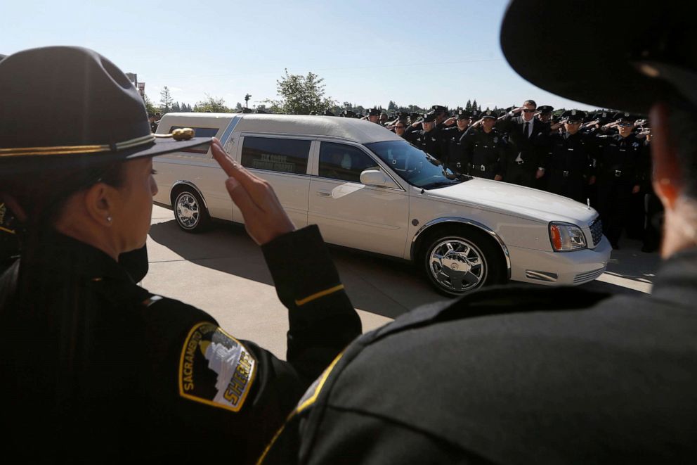 PHOTO: Law enforcement officers salute the hearse carrying the casket of Sacramento Police Officer Tara O'Sullivan to the Bayside Adventure Church for memorial services in Roseville, Calif., June 27, 2019.