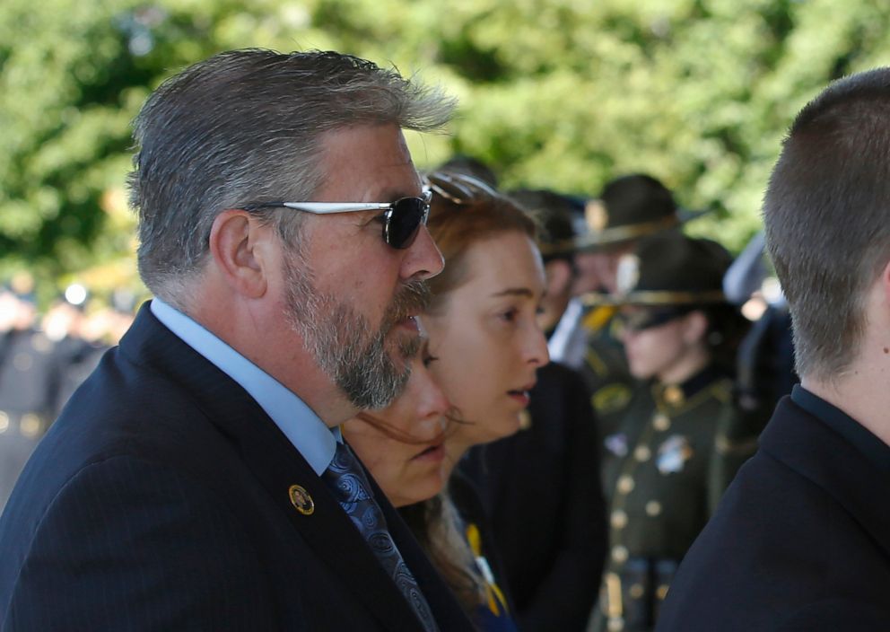 PHOTO: Denis O Sullivan, left, and his wife, Kelley, follow the flag draped casket of their daughter Sacramento Police Officer Tara OSullivan into the Bayside Church, Adventure Campus in Roseville, Calif., for a memorial service, June 27, 2019.