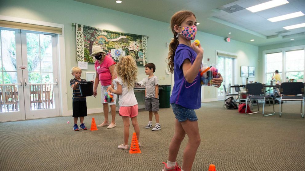 PHOTO: Campers play games while wearing Covid-19 masks at McKee Botanical Garden in Treasure Coast, Fla., March 25, 2021.