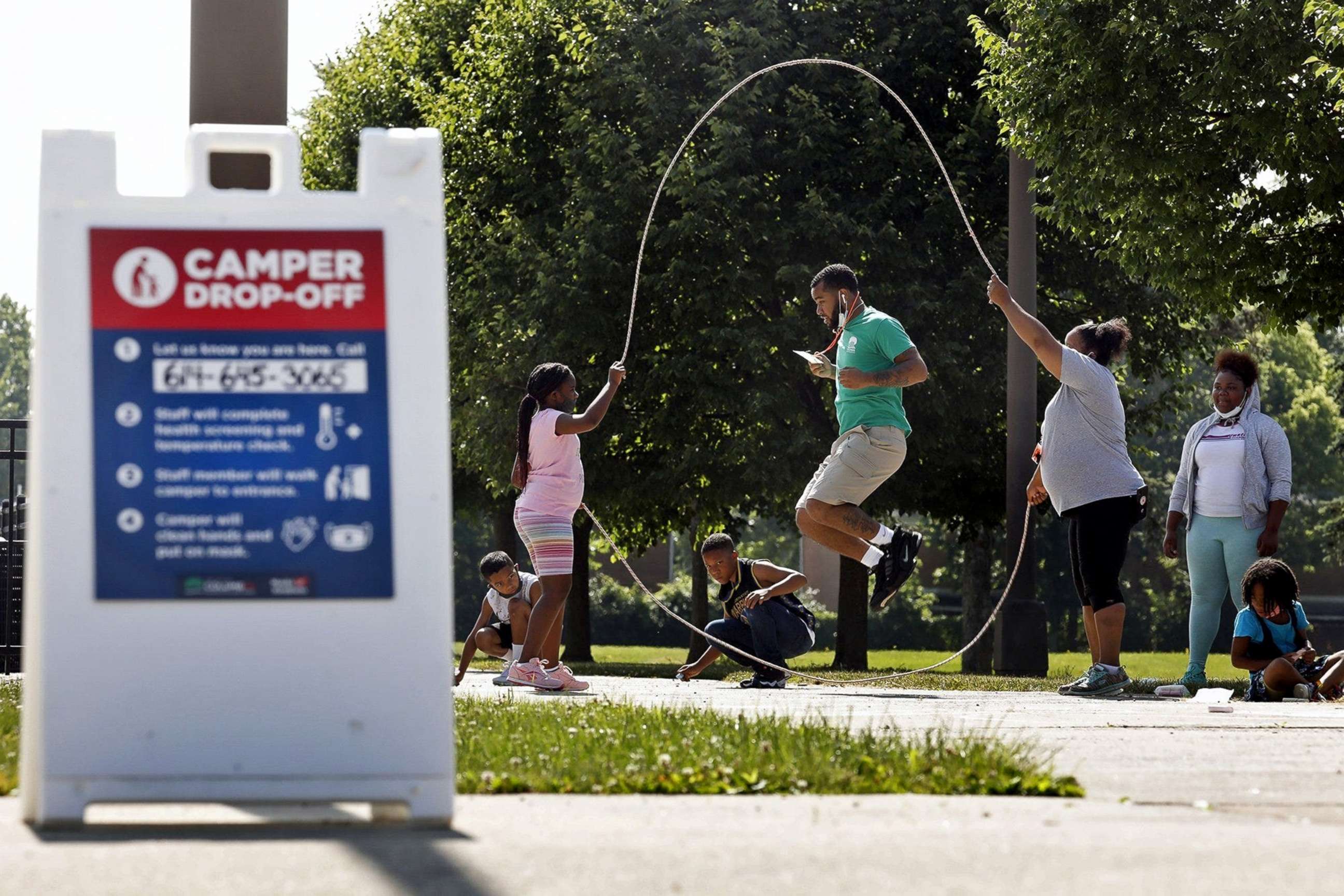 PHOTO: Camp counselors and campers play jump rope while wearing Covid-19 masks at the Barnett Recreation Center, in Columbus, Ohio, June 19, 2020. 