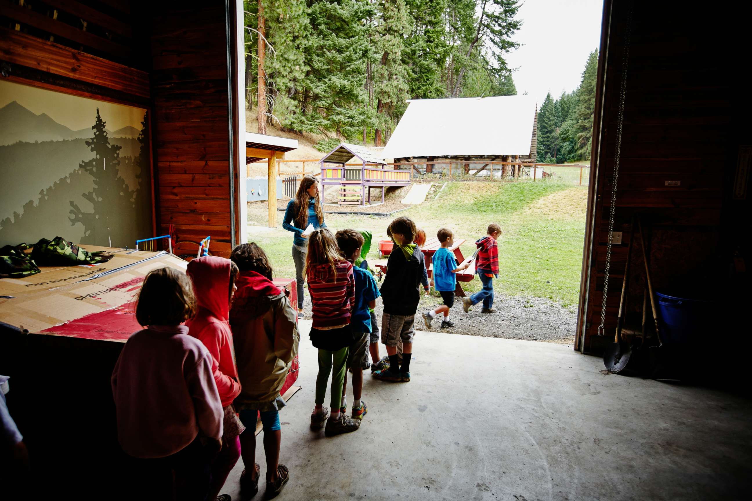 PHOTO: Stock photo of camp counselor lining-up summer camp students to go outside.