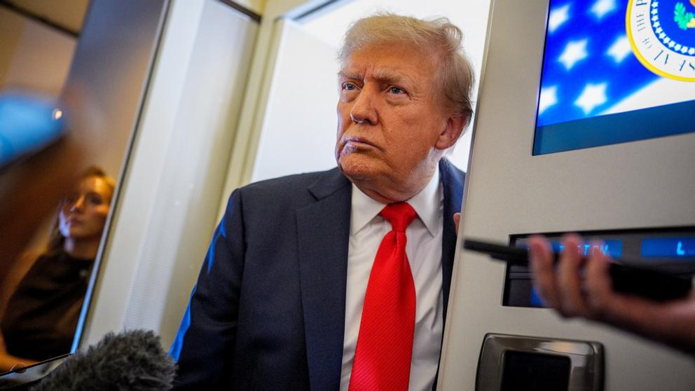 PHOTO: President Donald Trump speaks to reporters aboard Air Force One in the air on August 15, 2025, en route to Anchorage.