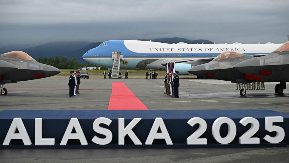 PHOTO: F-22 fighter jets are seen on the tarmac with Air Force One in the distance after US President Donald Trump landed at Joint Base Elmendorf-Richardson in Anchorage, Alaska, August 15, 2025.