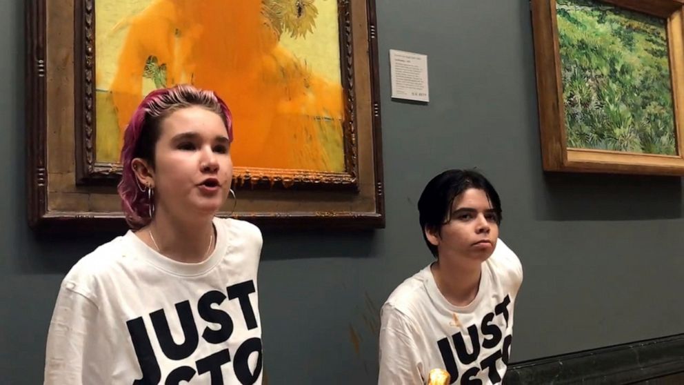 PHOTO: Two protesters who have thrown tinned soup at Vincent Van Gogh's famous 1888 work Sunflowers at the National Gallery in London, Oct. 14, 2022.