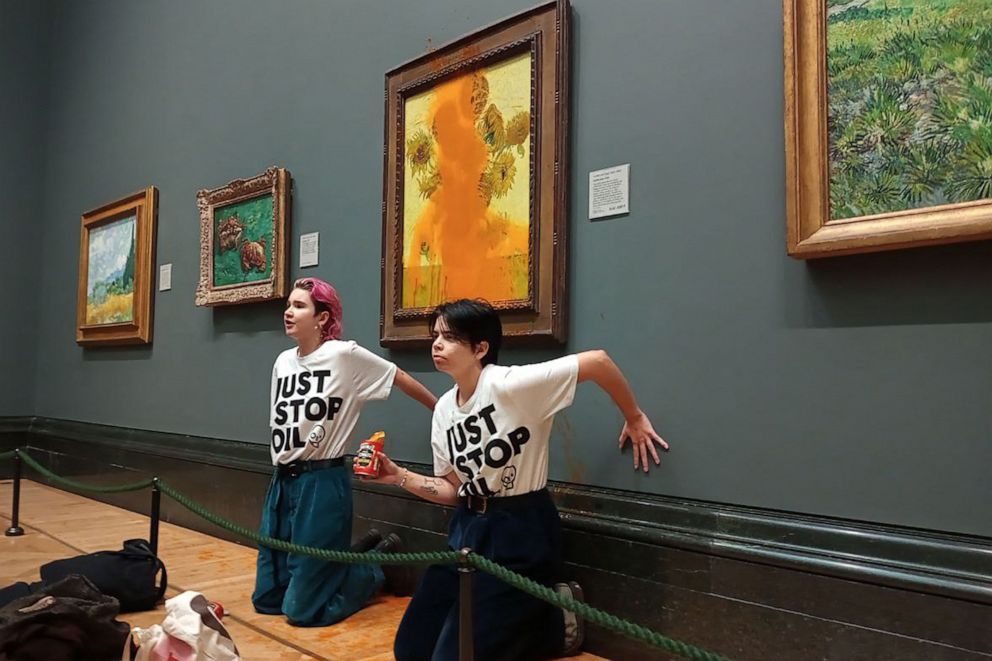 PHOTO: The Just Stop Oil climate campaign group shows activists with their hands glued to the wall under Vincent van Gogh's "Sunflowers" after throwing tomato soup on the painting at the National Gallery in central London on Oct. 14, 2022.