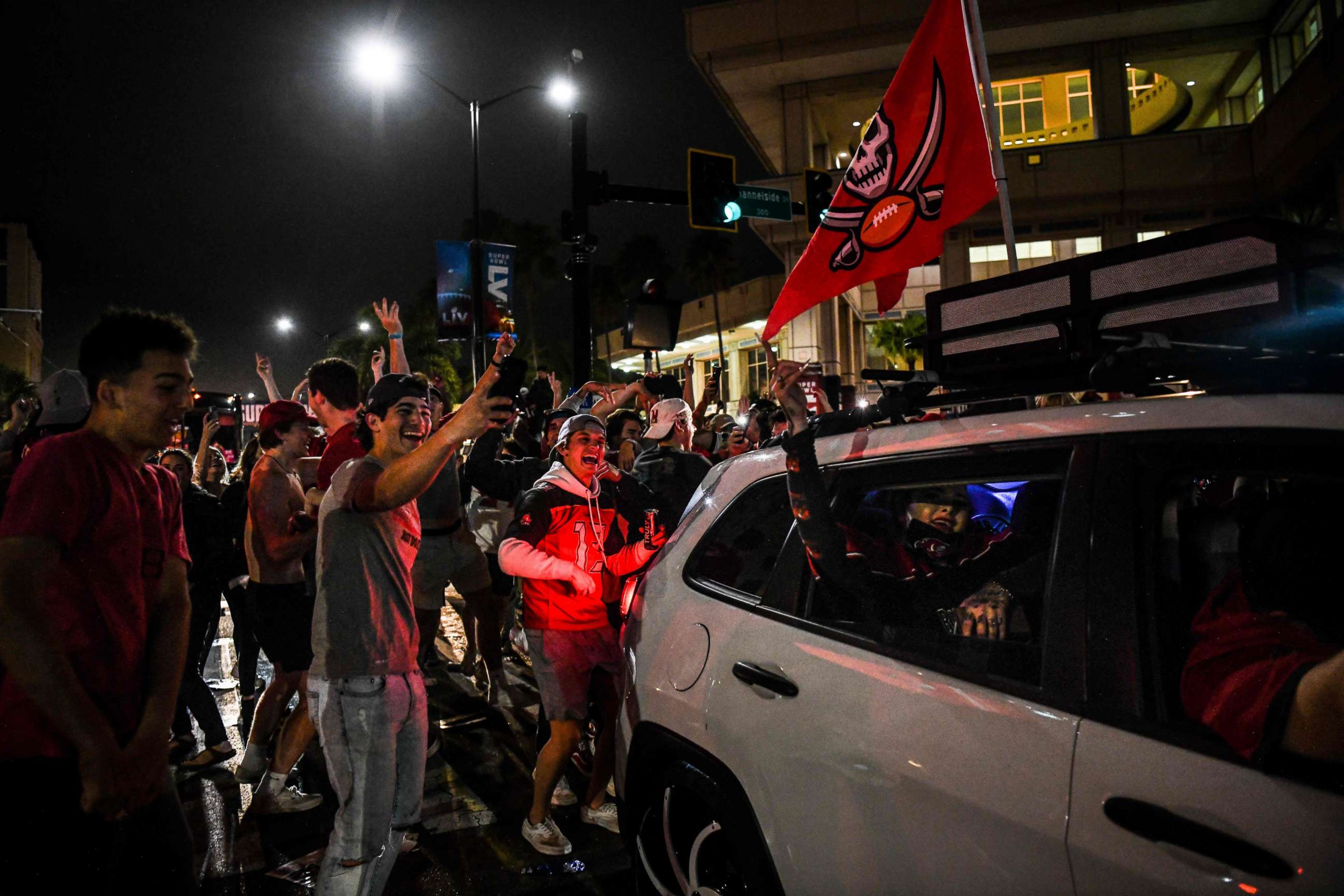 PHOTO: Tampa Bay Buccaneers fans celebrate their victory over the Kansas City Chiefs during Super Bowl LV in a street in downtown Tampa, Fla., Feb. 7, 2021.