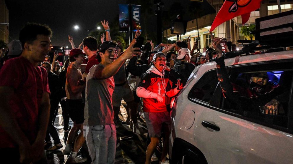 PHOTO: Tampa Bay Buccaneers fans celebrate their victory over the Kansas City Chiefs during Super Bowl LV in a street in downtown Tampa, Fla., Feb. 7, 2021.