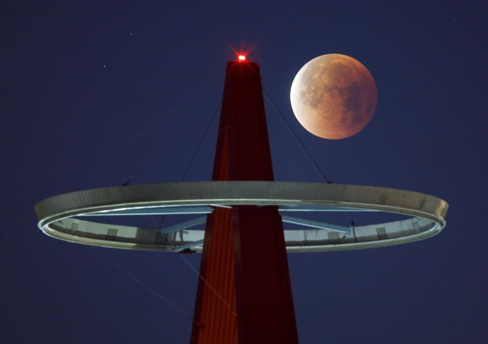 PHOTO: A super moon shines its blood red colors during a full eclipse above the Big A Sign of Angel Stadium in Anaheim, Calif., on Jan., 31, 2018.