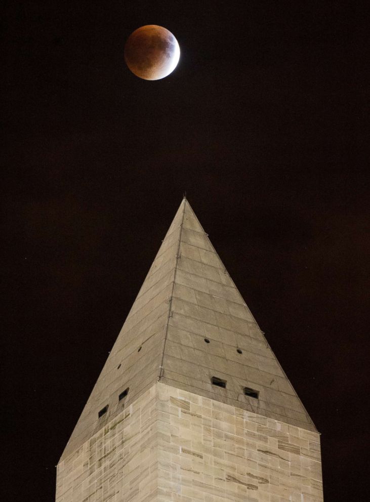 PHOTO: A perigee full moon, or supermoon, is seen behind the Washington Monument during a total lunar eclipse on Sept. 27, 2015, in Washington.