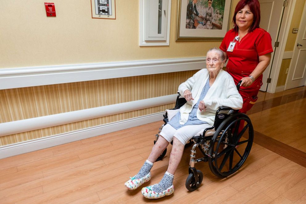PHOTO: A nurse at Coventry Court Health Center in Anaheim, Calif., wheels Neva Shinkle to her room to be bathed with a special soap to help fight infections.