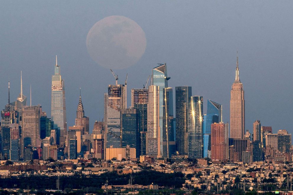 PHOTO: The full moon, known as the "Super Pink Moon", rises over the skyline of New York City, seen from West Orange, in New Jersey, April 26, 2021.