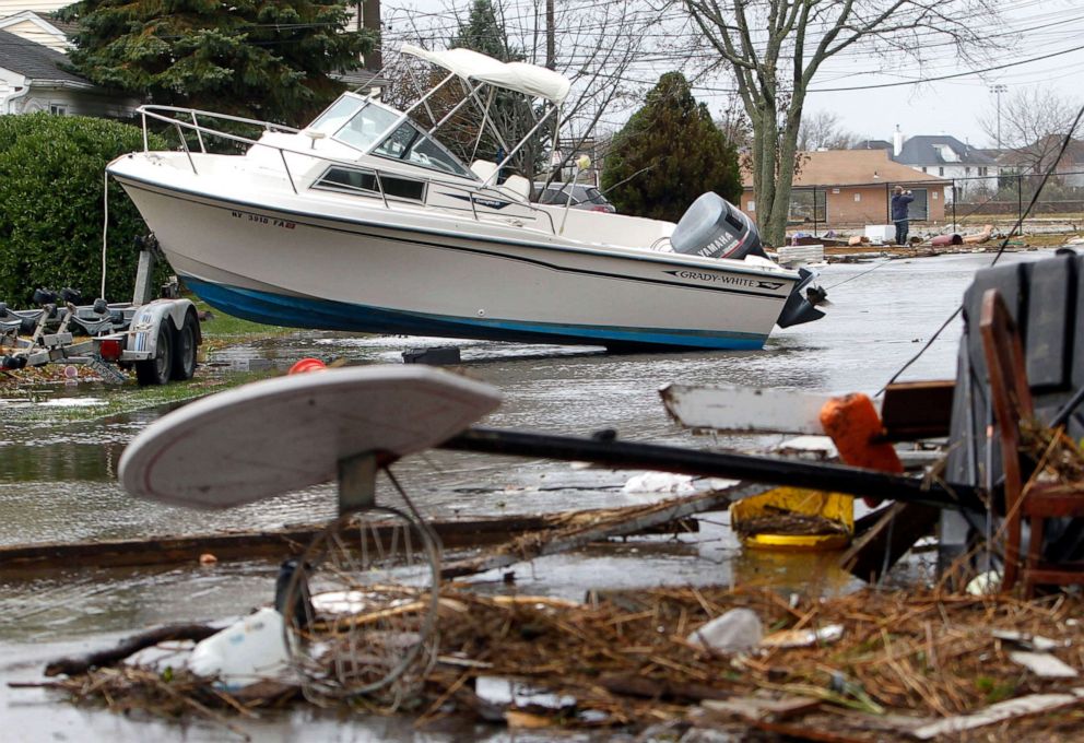 PHOTO: As flood waters recede, a boat and other wreckage litter a street in the aftermath of superstorm Sandy, Oct. 30, 2012, in Massapequa, N.Y.
