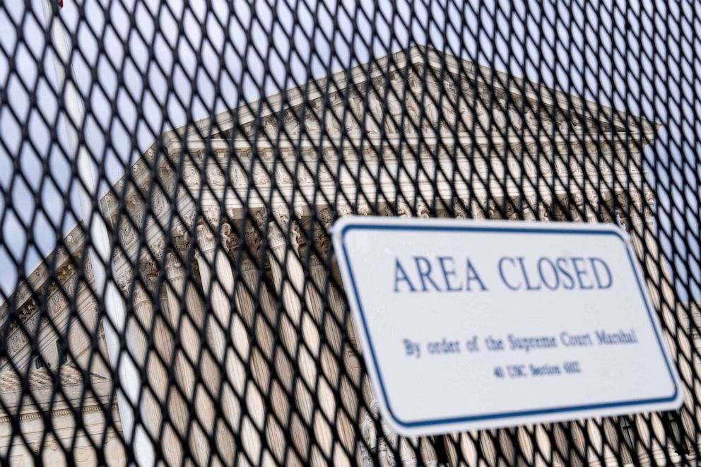 PHOTO: The Supreme Court is seen through a fence with a "Closed Area" sign in Washington, DC, on May 11, 2022.