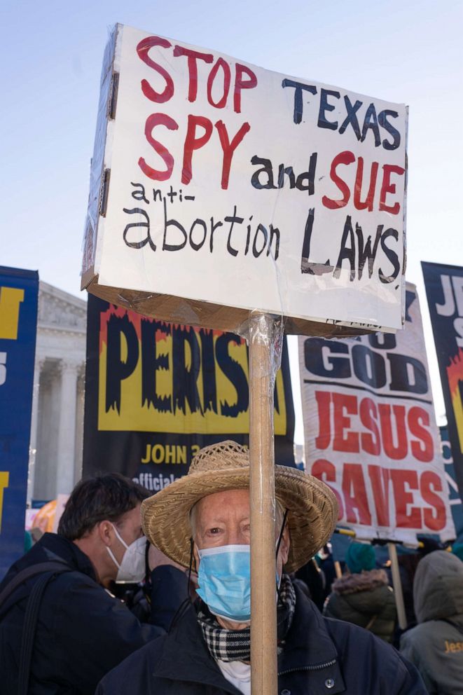 PHOTO: "Stop Texas Spy and Sue anti-abortion laws" reads the sign as Abortion rights advocates and anti-abortion protesters gathered as the U.S. Supreme Court in Washington, Dec. 1, 2021.