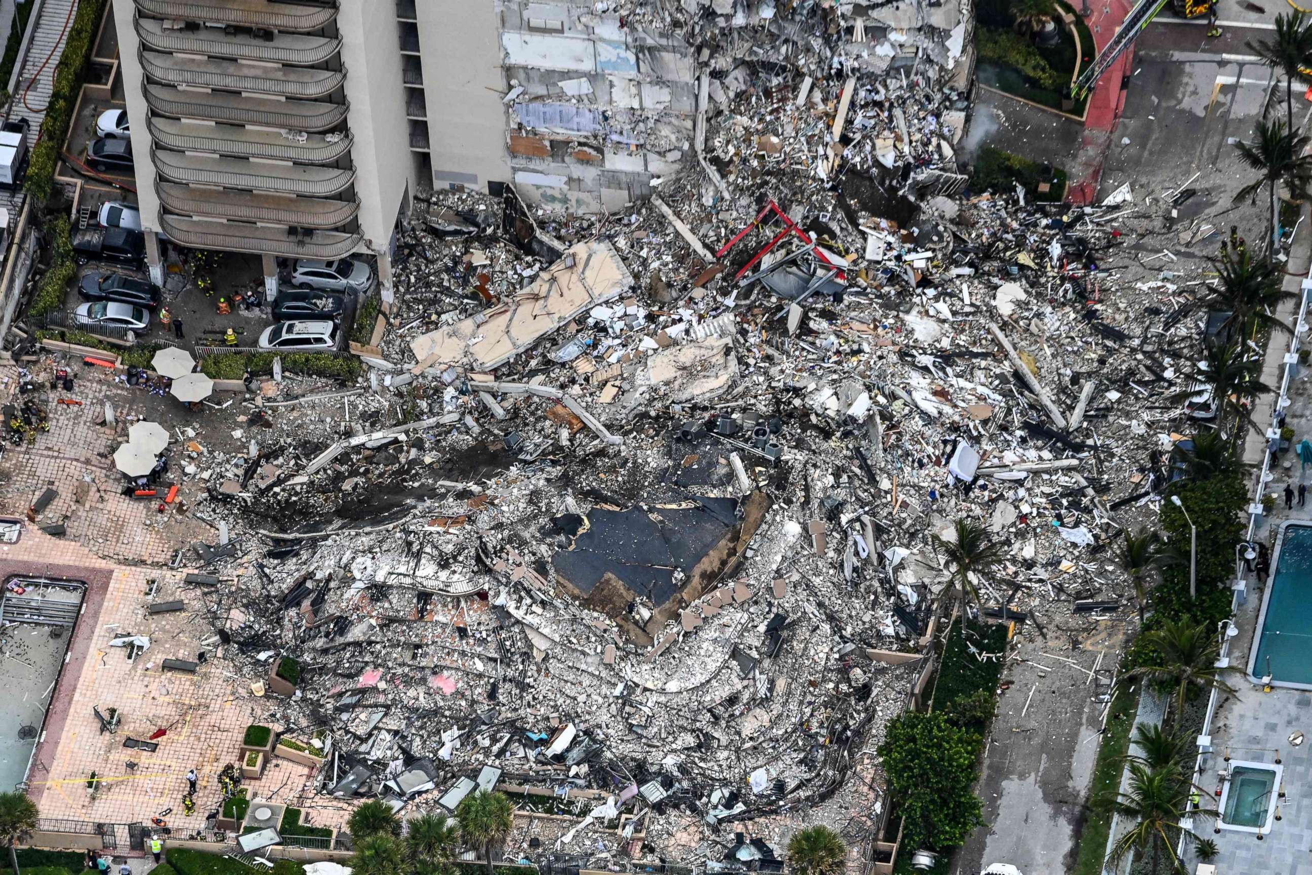 PHOTO: (FILES) In this file aerial view, shows search and rescue personnel working on site after the partial collapse of the Champlain Towers South in Surfside, north of Miami Beach, on June 24, 2021. 