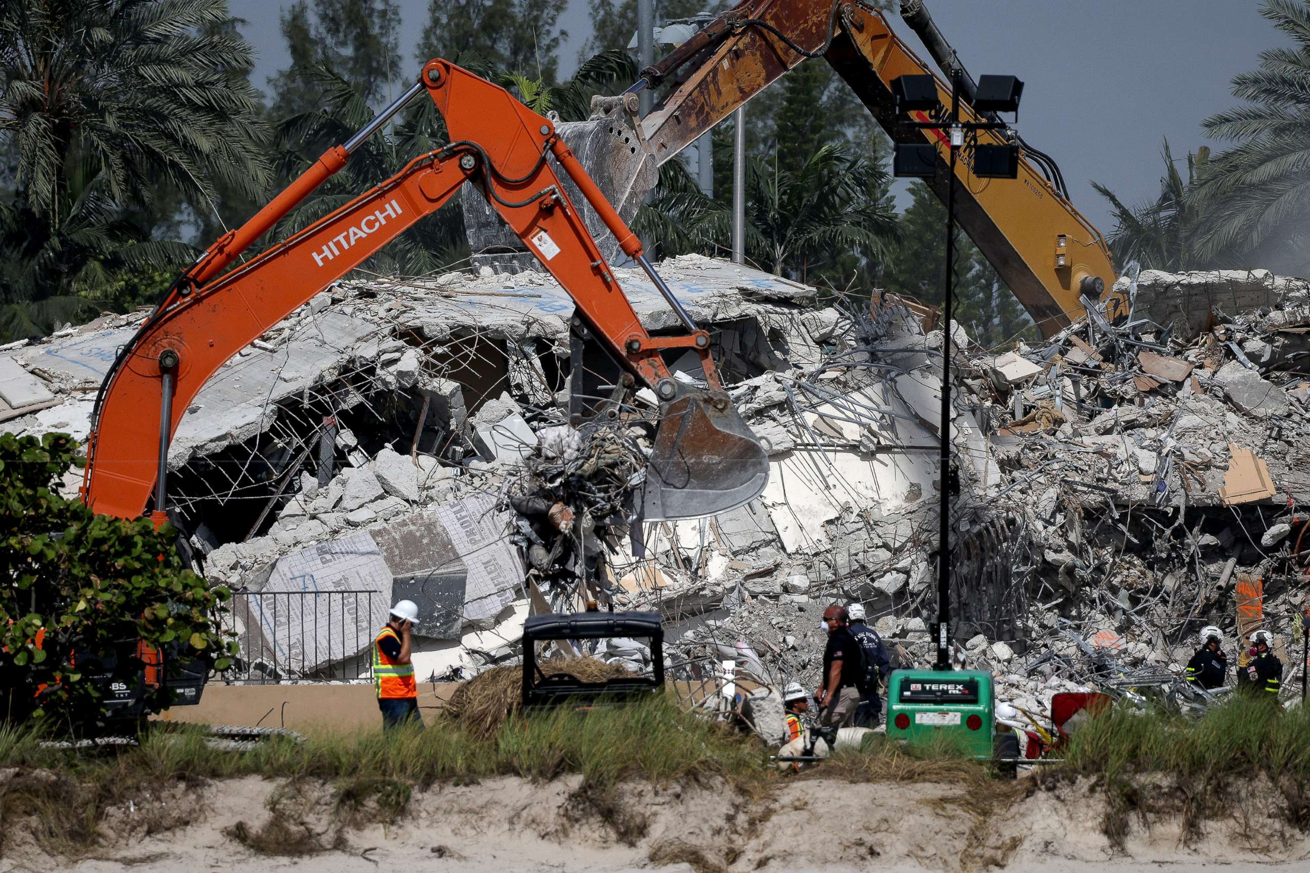 PHOTO: Excavators dig through the remains from the collapsed 12-story Champlain Towers South condo building, July 9, 2021, in Surfside, Fla.