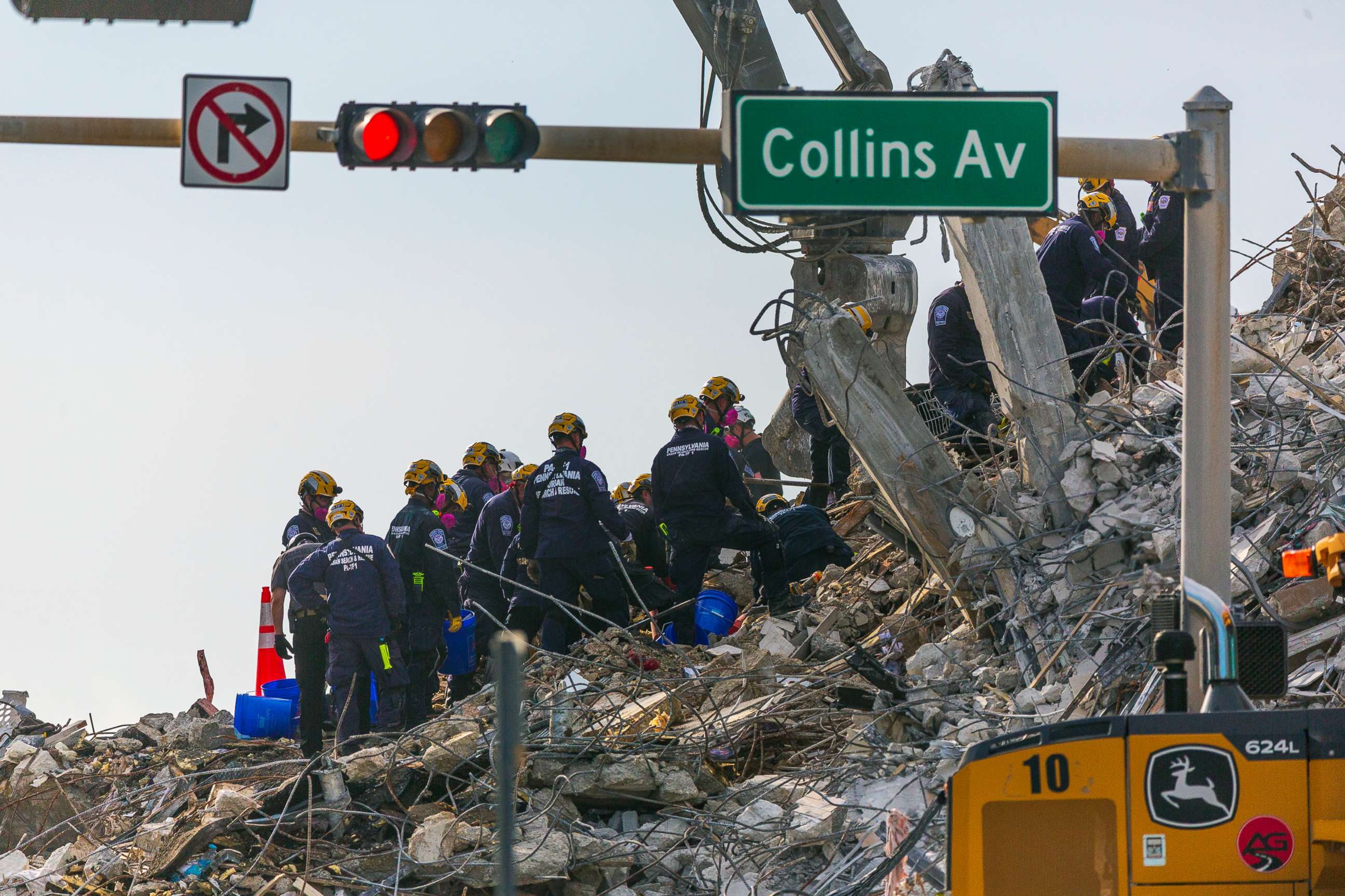 PHOTO: Rescue workers continue working on a pile of debris, July 5, 2021 after the partially collapsed 12-story Champlain Towers South condo was taken down on July 4 with a controlled demolition in Surfside, Fla.