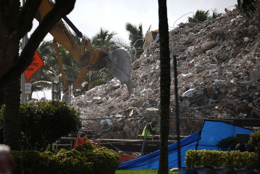 PHOTO: SURFSIDE, FLORIDA - JULY 13: Excavators dig through the pile of debris from the collapsed 12-story Champlain Towers South condo building following a severe thunderstorm on July 13, 2021 in Surfside, Florida. 