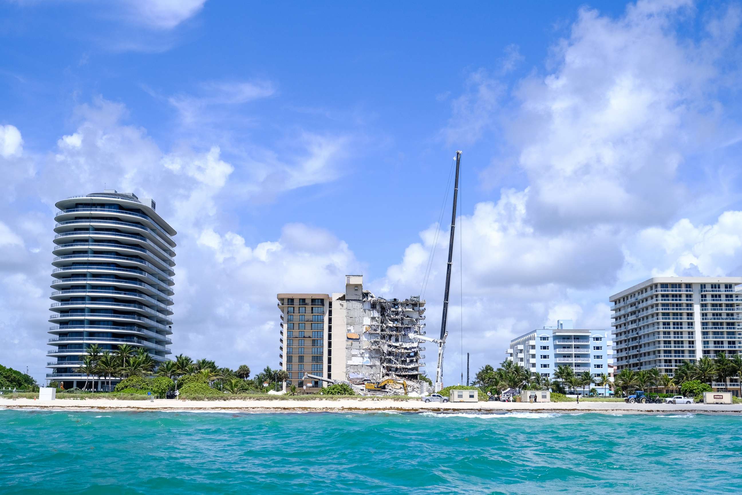 PHOTO: Heavy machinery works next to the partially collapsed residential building as search and rescue operations continue, in Surfside near Miami Beach, Fla., June 27, 2021.